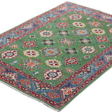 Full view at an angle of green & red Kazak-inspired wool rug 29347.