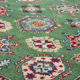 Pattern detail of green & red Kazak-inspired wool rug 29347.