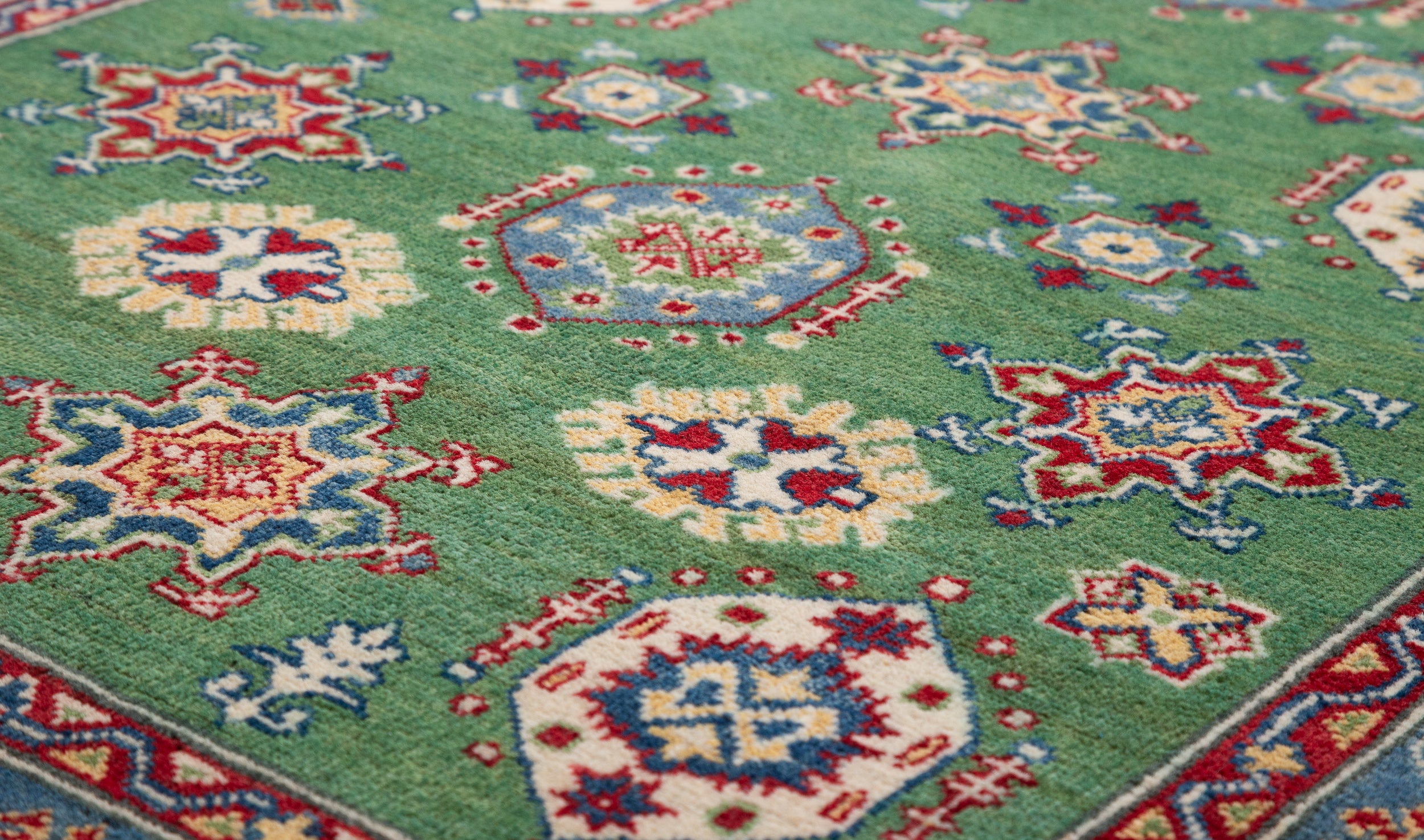 Pattern detail of green & red Kazak-inspired wool rug 29347.