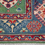 Border and edge detail of green & red Kazak-inspired wool rug 29347.