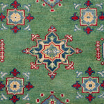Pattern detail of green & red Kazak-inspired wool rug 29347.