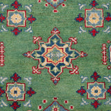 Pattern detail of green & red Kazak-inspired wool rug 29347.