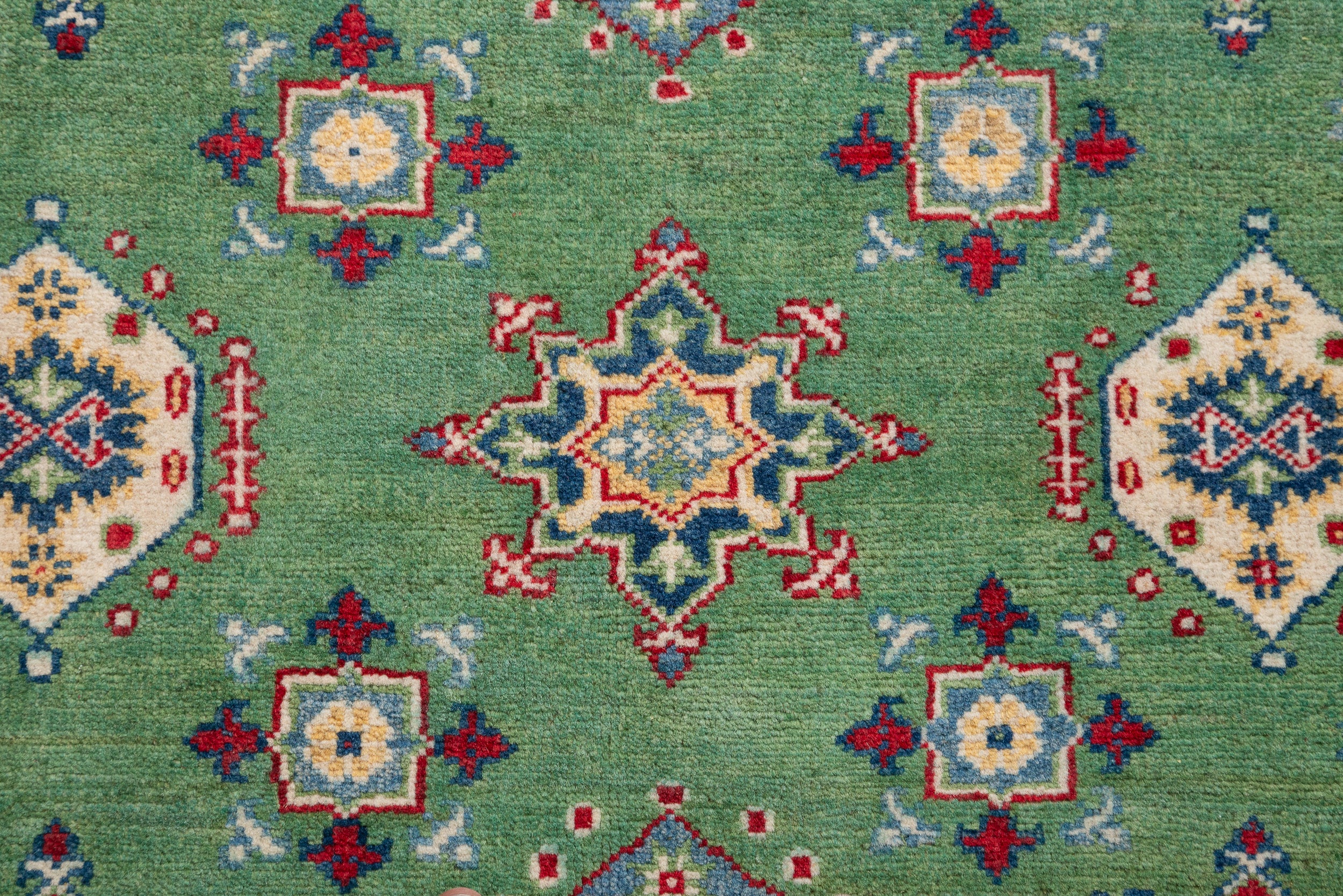 Pattern detail of green & red Kazak-inspired wool rug 29347.
