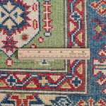 Wool pile close-up of green & red Kazak-inspired wool rug 29347.