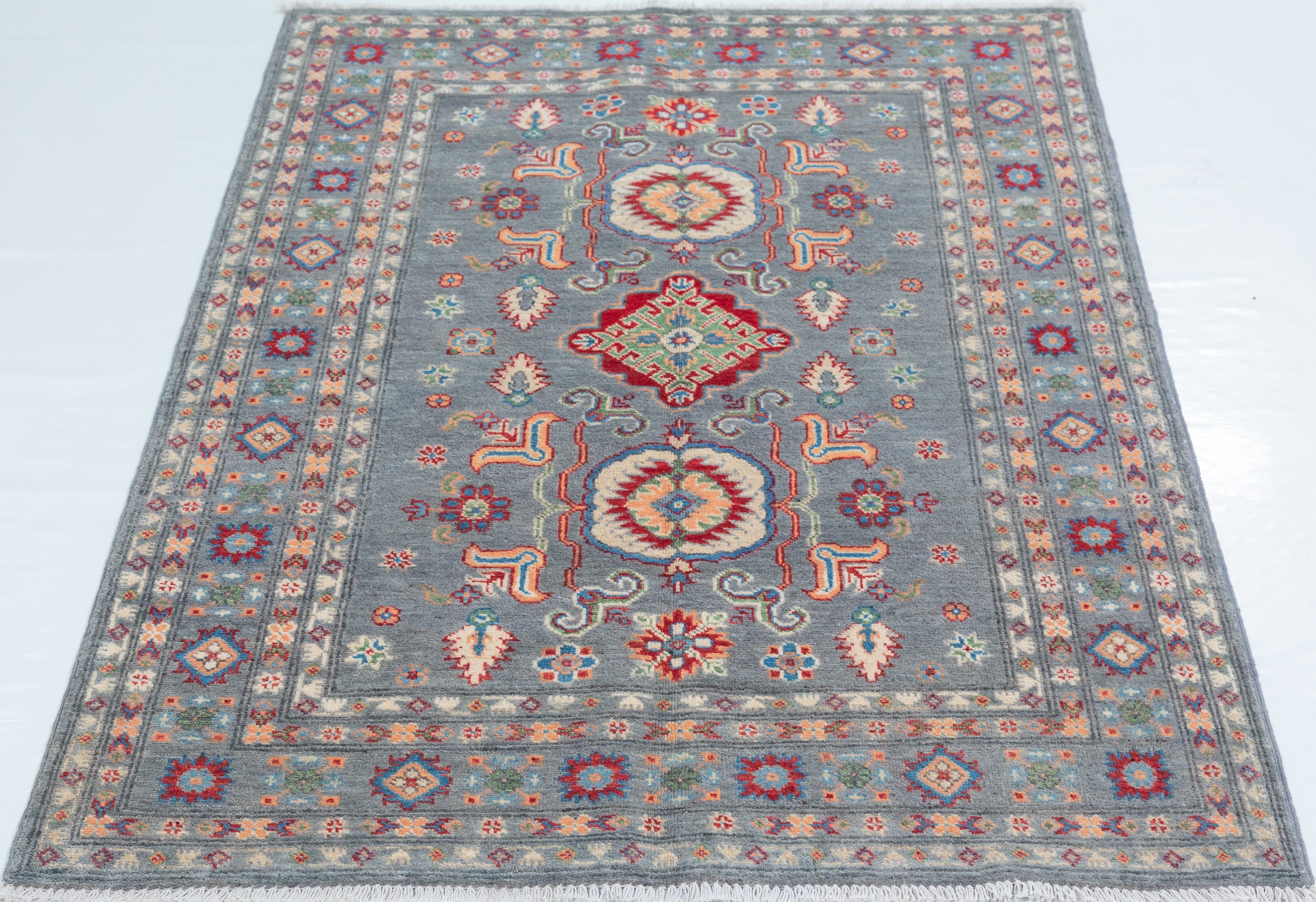 Full view from a low angle of blue & ivory Kazak-inspired wool rug 29645.