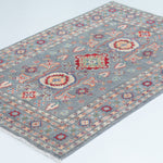 Full view at an angle of blue & ivory Kazak-inspired wool rug 29645.