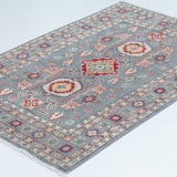 Full view at an angle of blue & ivory Kazak-inspired wool rug 29645.