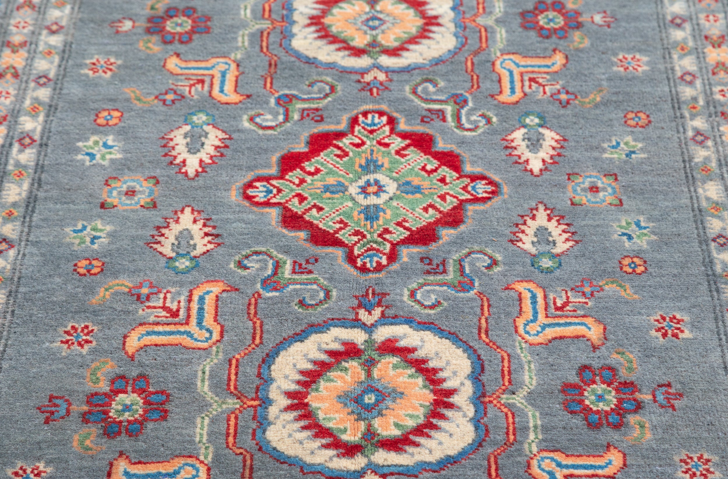 Pattern detail of blue & ivory Kazak-inspired wool rug 29645.