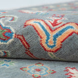 Folded edge and wool pile of blue & ivory Kazak-inspired wool rug 29645.