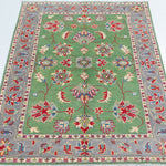 Full view from a low angle of green & ivory Kazak-inspired wool rug 29646.