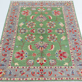 Full view from a low angle of green & ivory Kazak-inspired wool rug 29646.