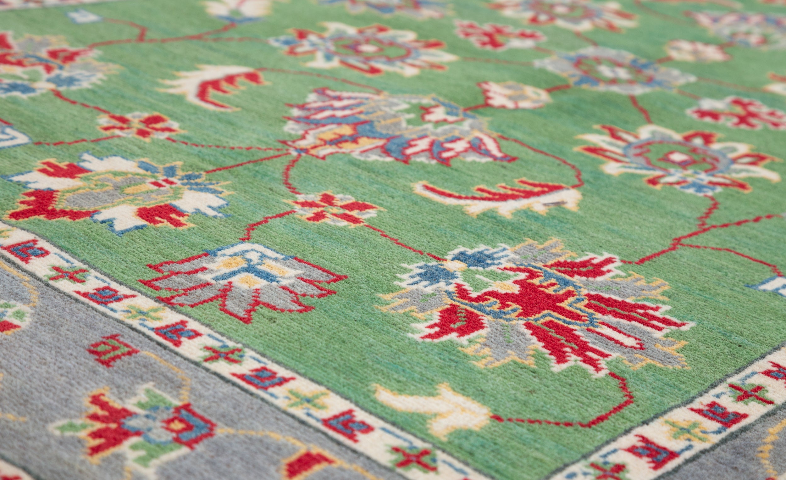 Pattern detail of green & ivory Kazak-inspired wool rug 29646.