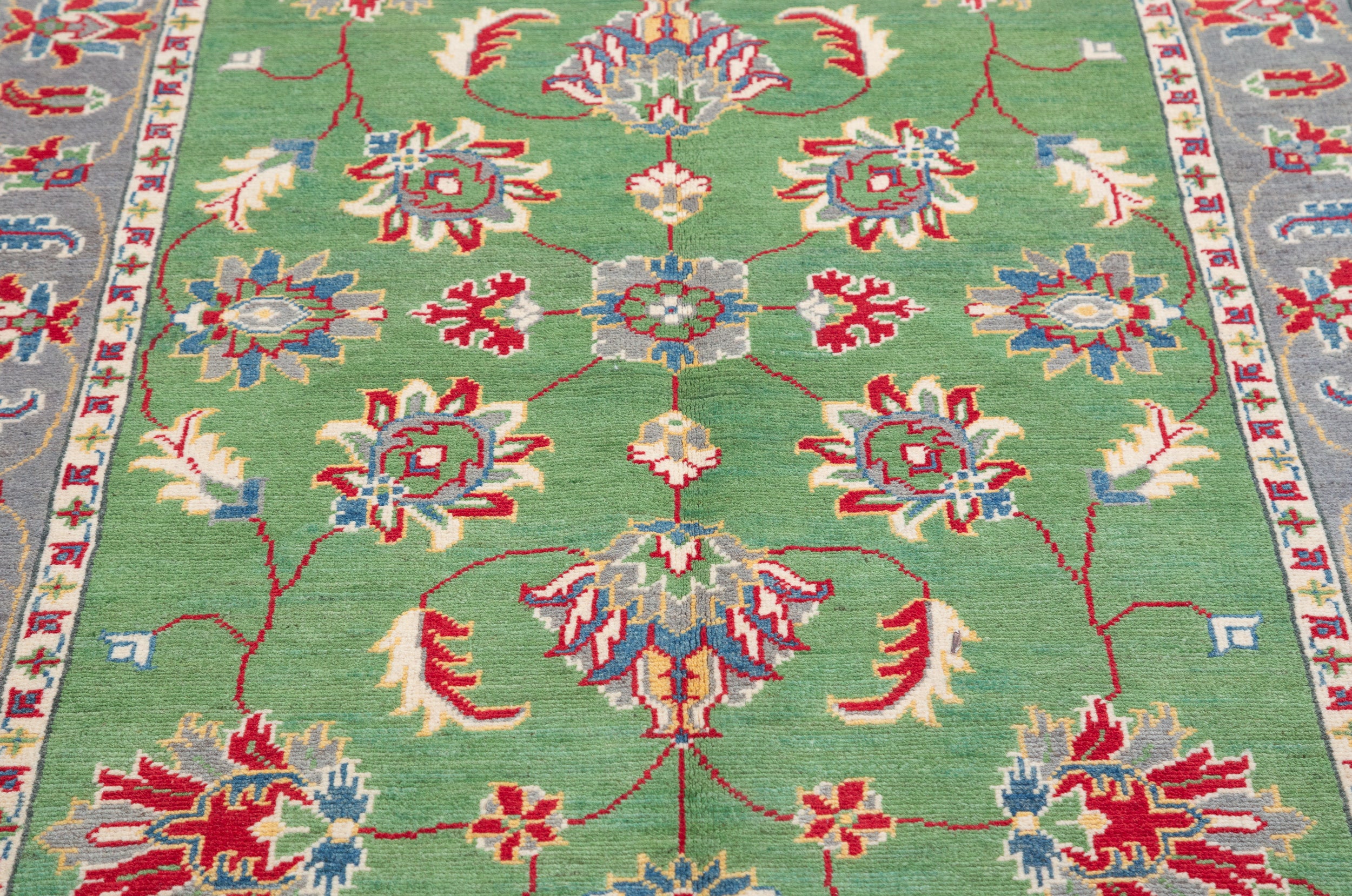 Pattern detail of green & ivory Kazak-inspired wool rug 29646.