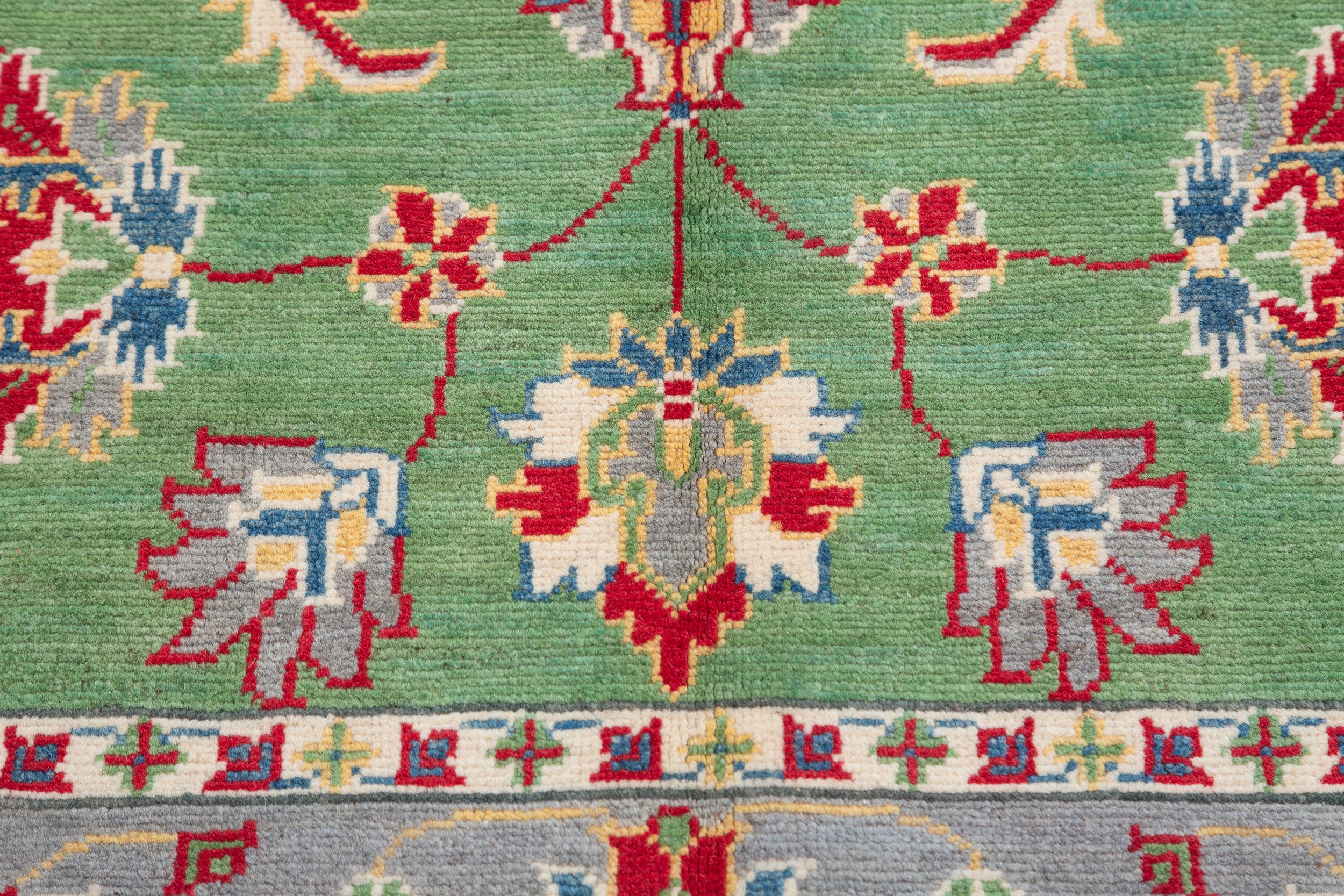 Pattern detail of green & ivory Kazak-inspired wool rug 29646.