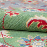 Folded edge and wool pile of green & ivory Kazak-inspired wool rug 29646.