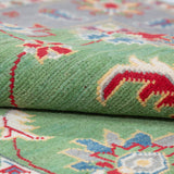 Folded edge and wool pile of green & ivory Kazak-inspired wool rug 29646.