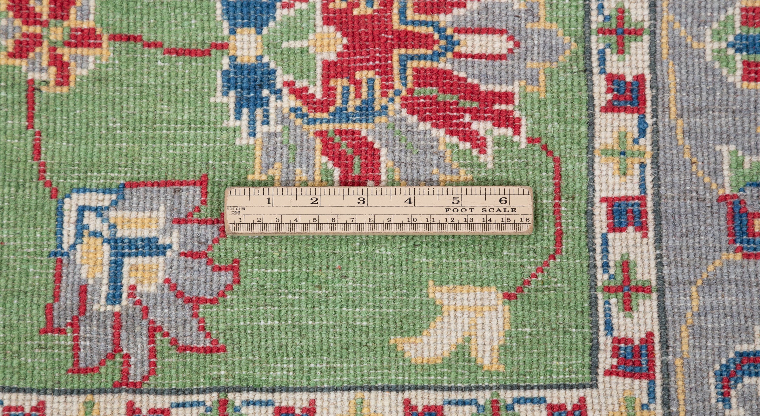 Wool pile close-up of green & ivory Kazak-inspired wool rug 29646.