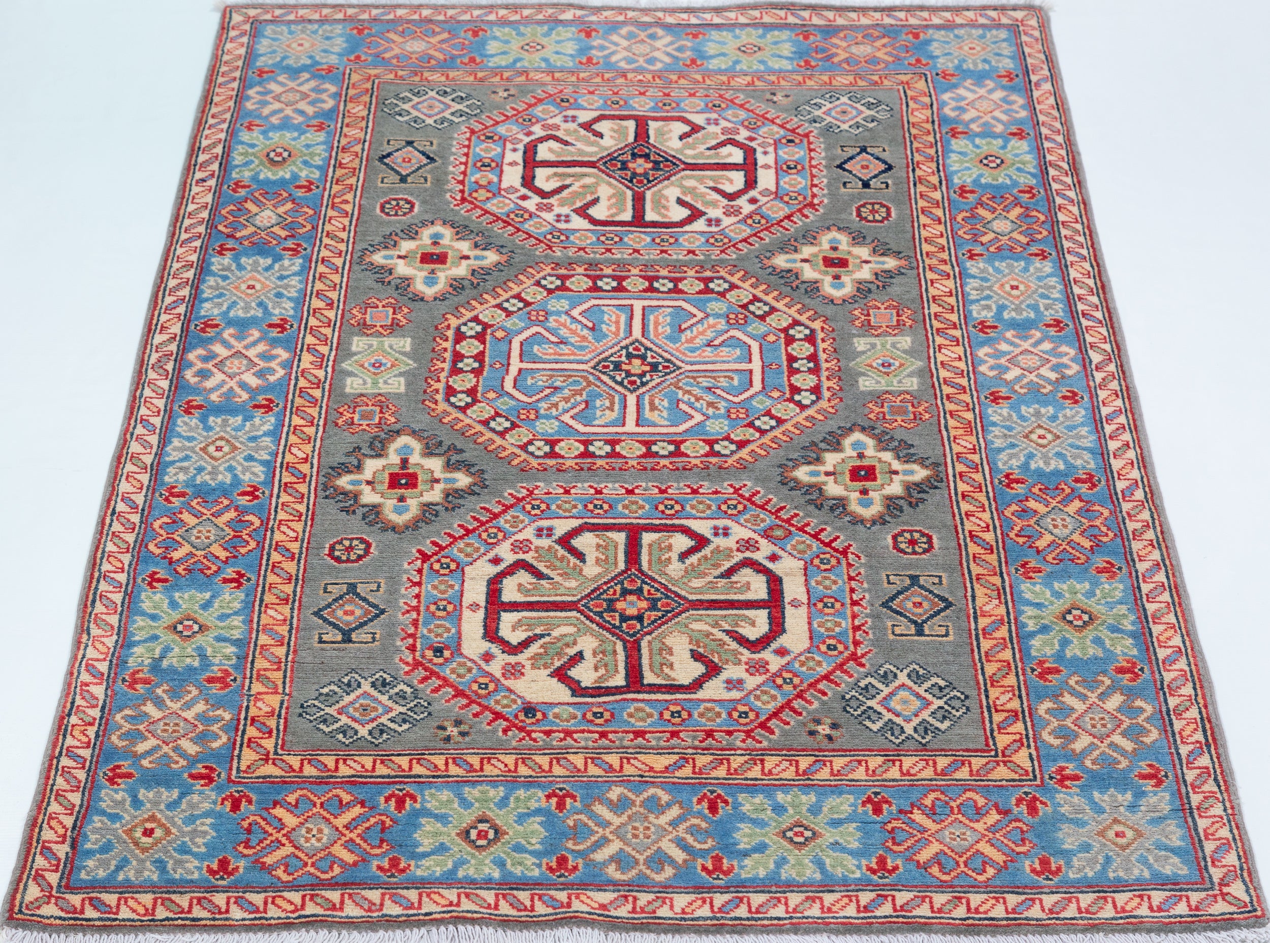 Full view from a low angle of blue & ivory Kazak-inspired wool rug 29647.