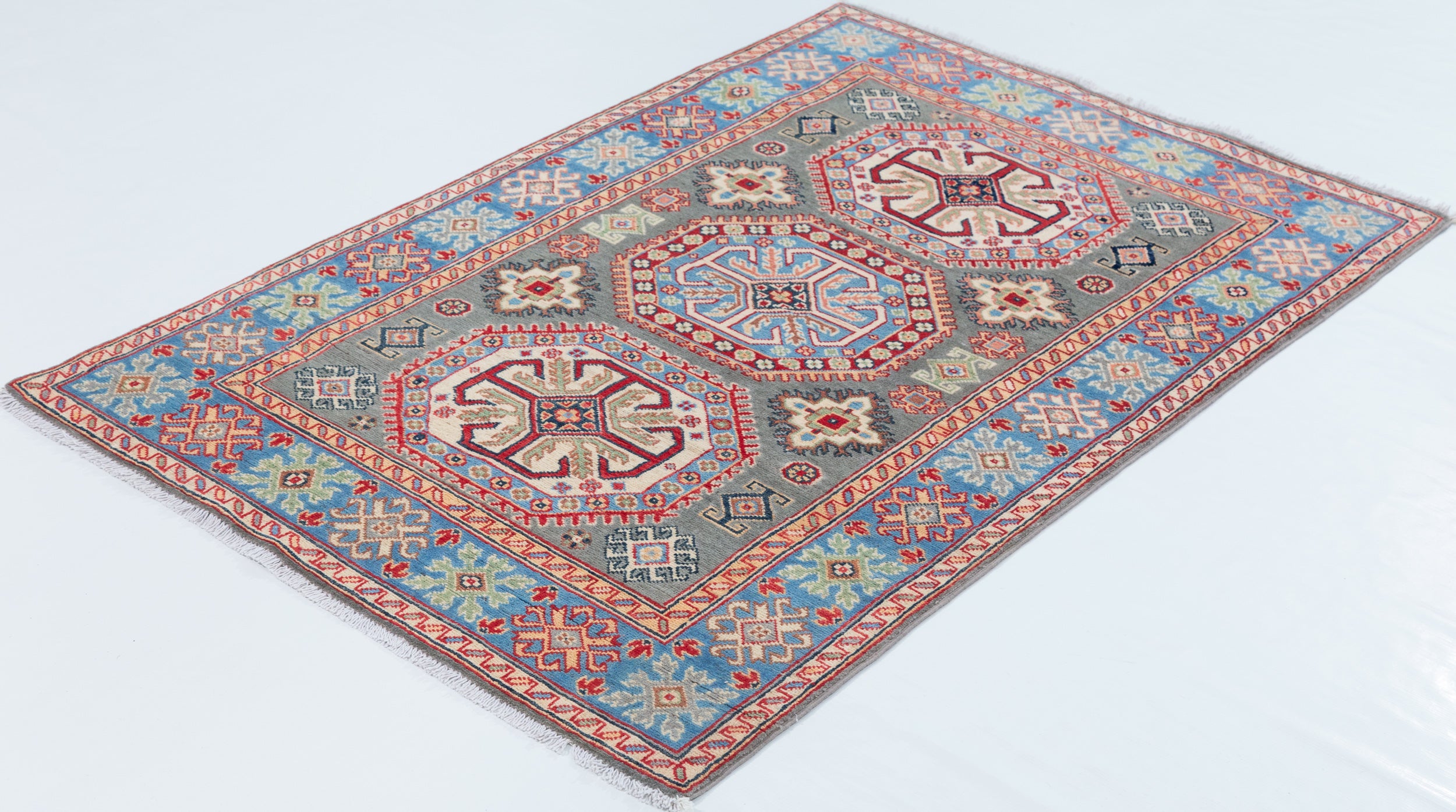 Full view at an angle of blue & ivory Kazak-inspired wool rug 29647.