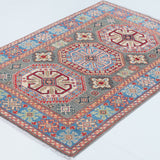 Full view at an angle of blue & ivory Kazak-inspired wool rug 29647.