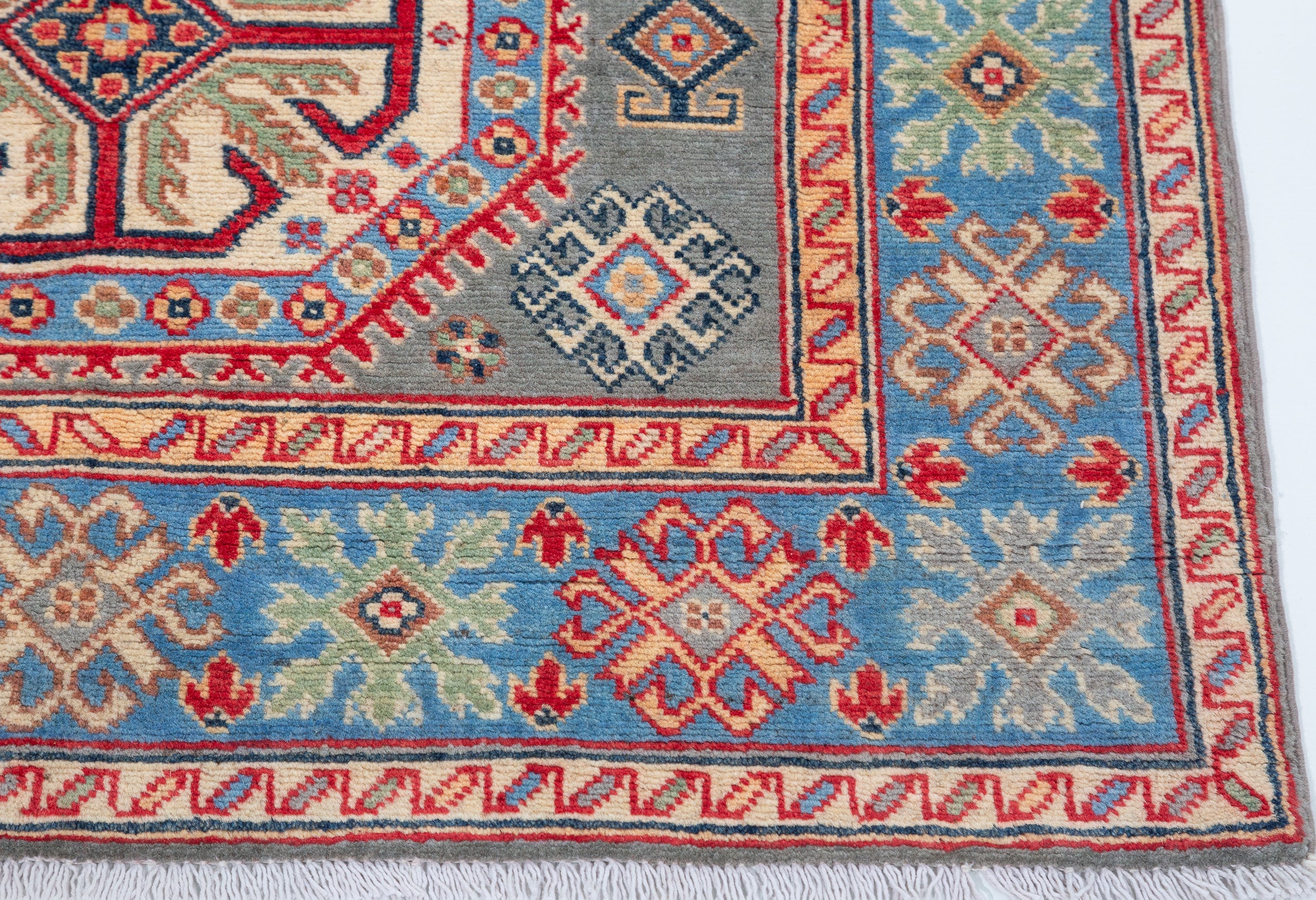 Border and edge detail of blue & ivory Kazak-inspired wool rug 29647.