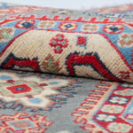 Folded edge and wool pile of blue & ivory Kazak-inspired wool rug 29647.