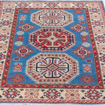 Full view from a low angle of blue & red Kazak-inspired wool rug 29648.