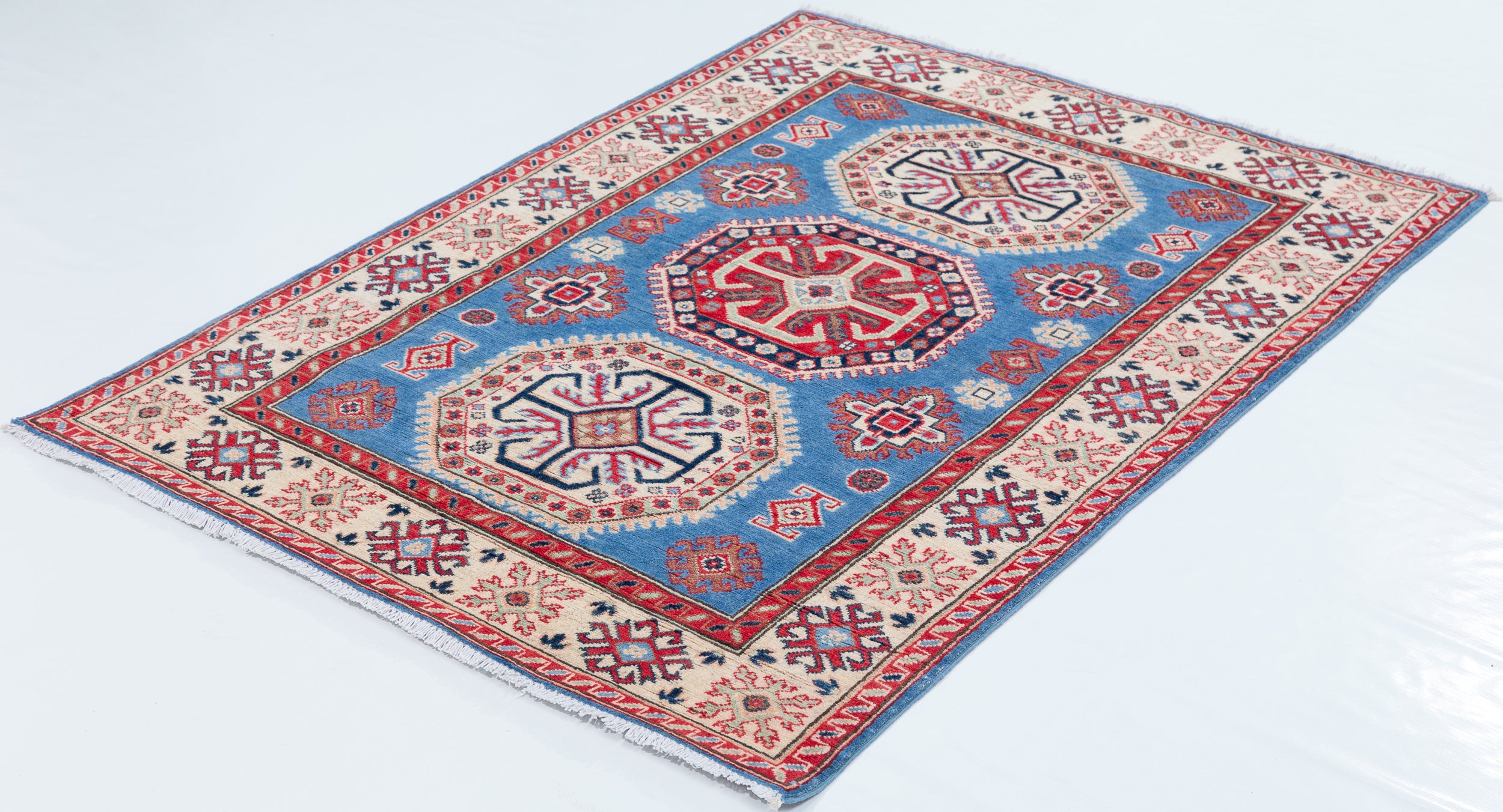Full view at an angle of blue & red Kazak-inspired wool rug 29648.
