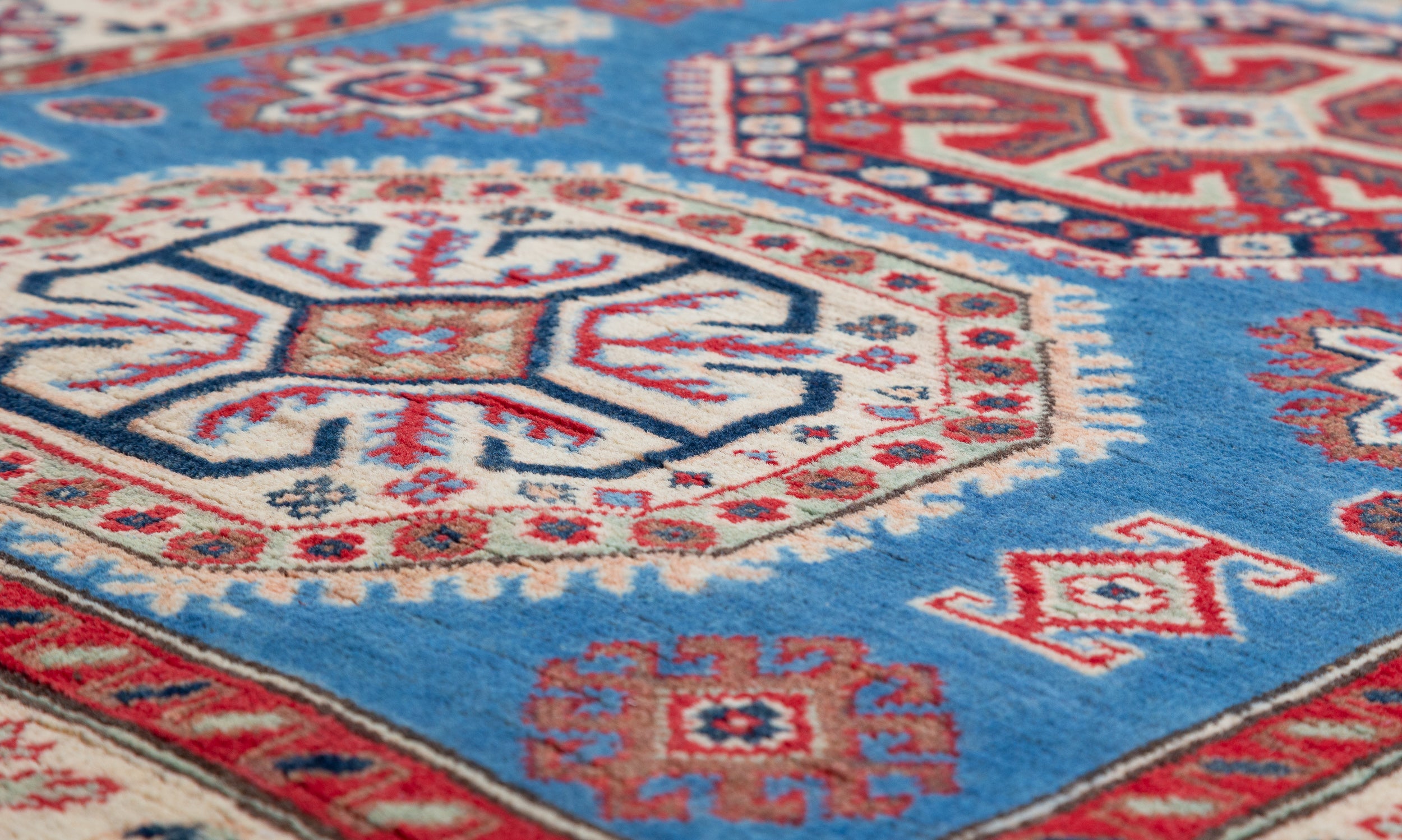 Pattern detail of blue & red Kazak-inspired wool rug 29648.