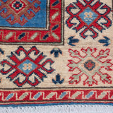 Border and edge detail of blue & red Kazak-inspired wool rug 29648.