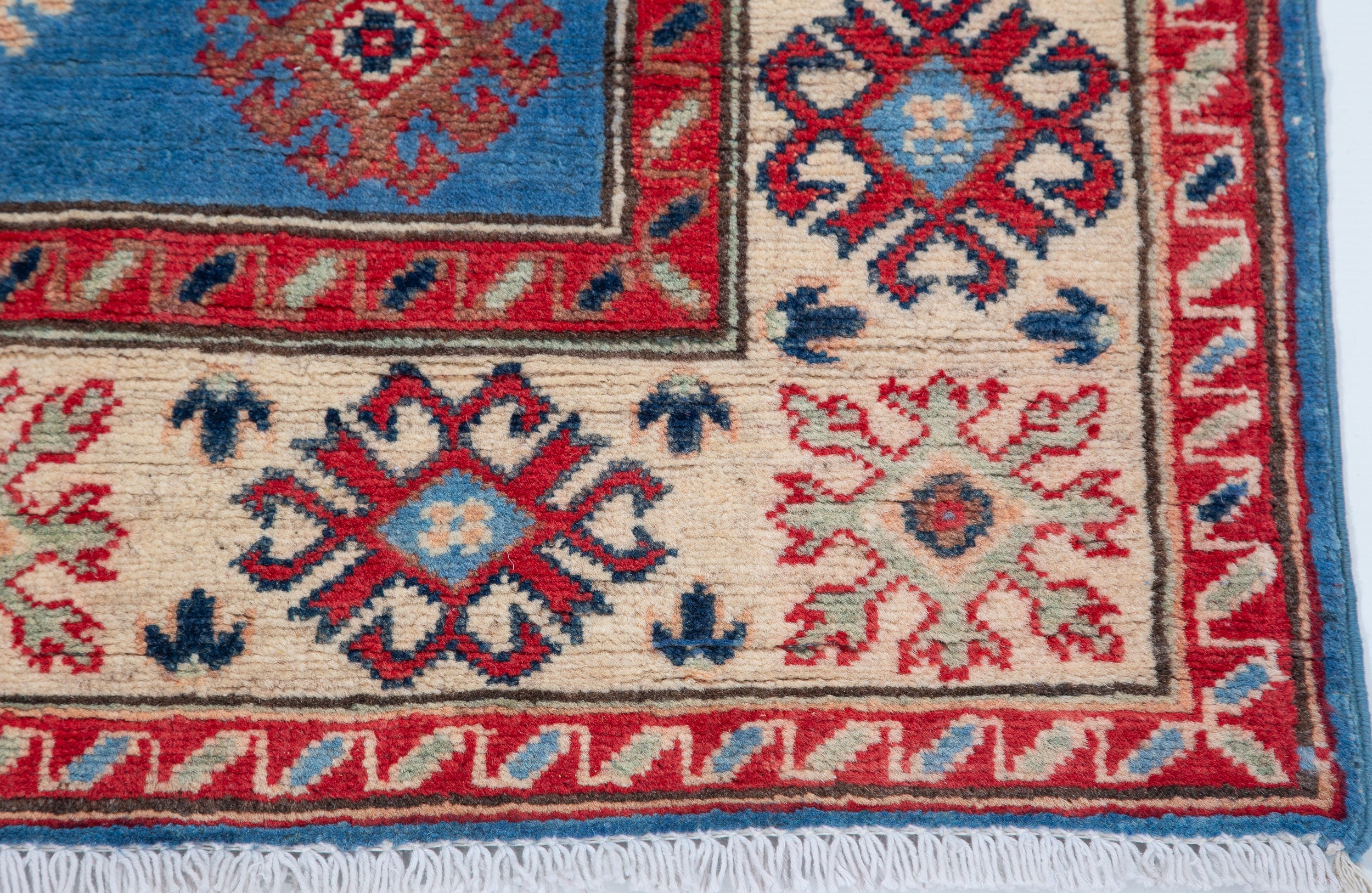 Border and edge detail of blue & red Kazak-inspired wool rug 29648.