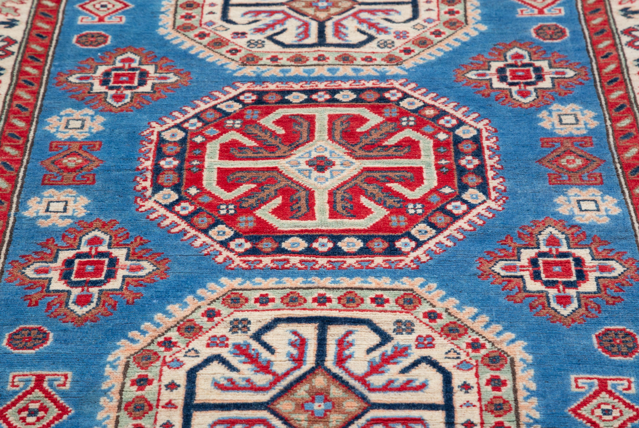 Pattern detail of blue & red Kazak-inspired wool rug 29648.