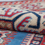 Folded edge and wool pile of blue & red Kazak-inspired wool rug 29648.