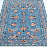 Full view from a low angle of blue & red Kazak-inspired wool rug 29649.