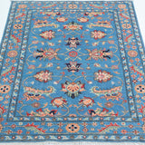 Full view from a low angle of blue & red Kazak-inspired wool rug 29649.
