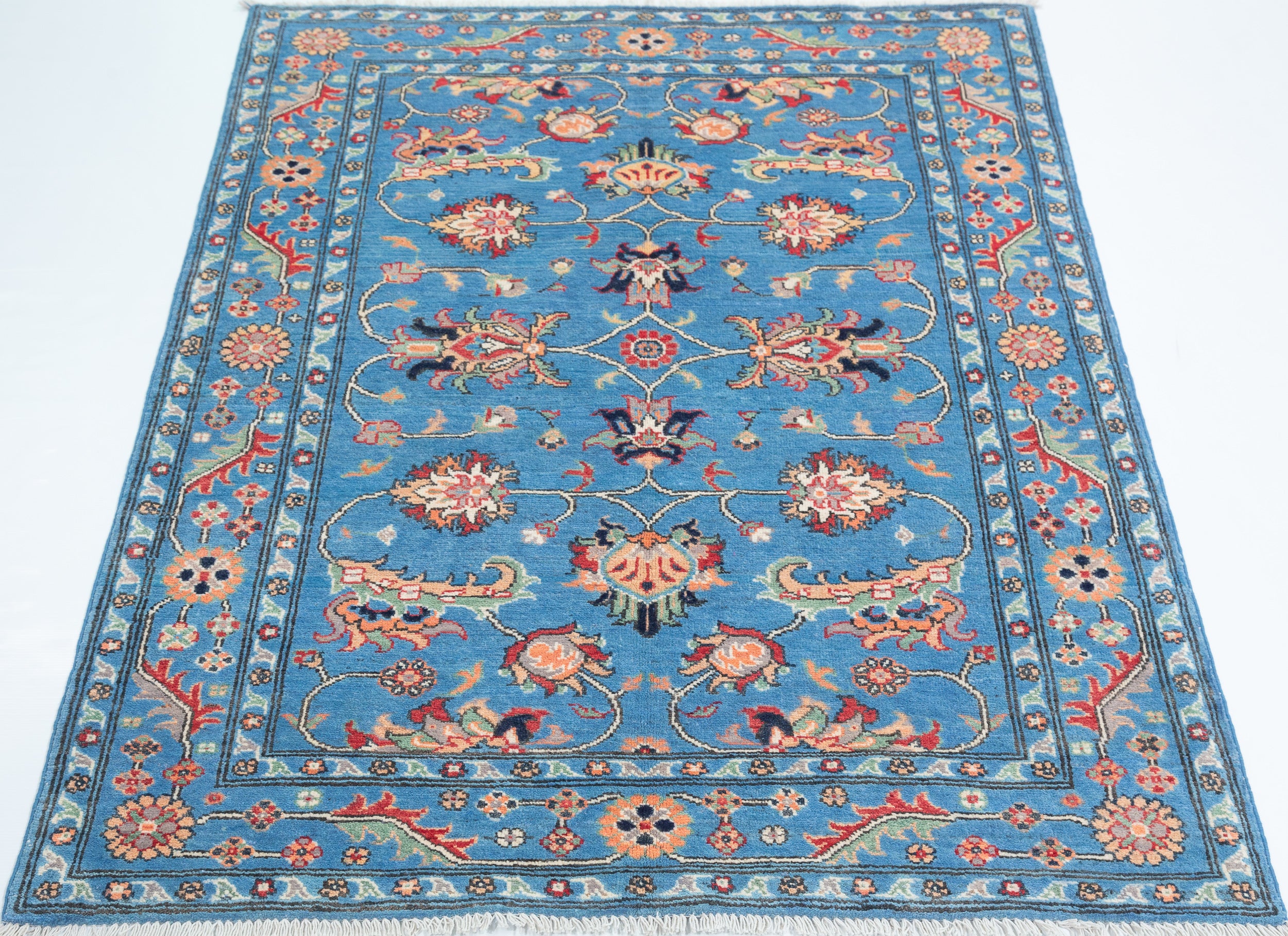 Full view from a low angle of blue & red Kazak-inspired wool rug 29649.