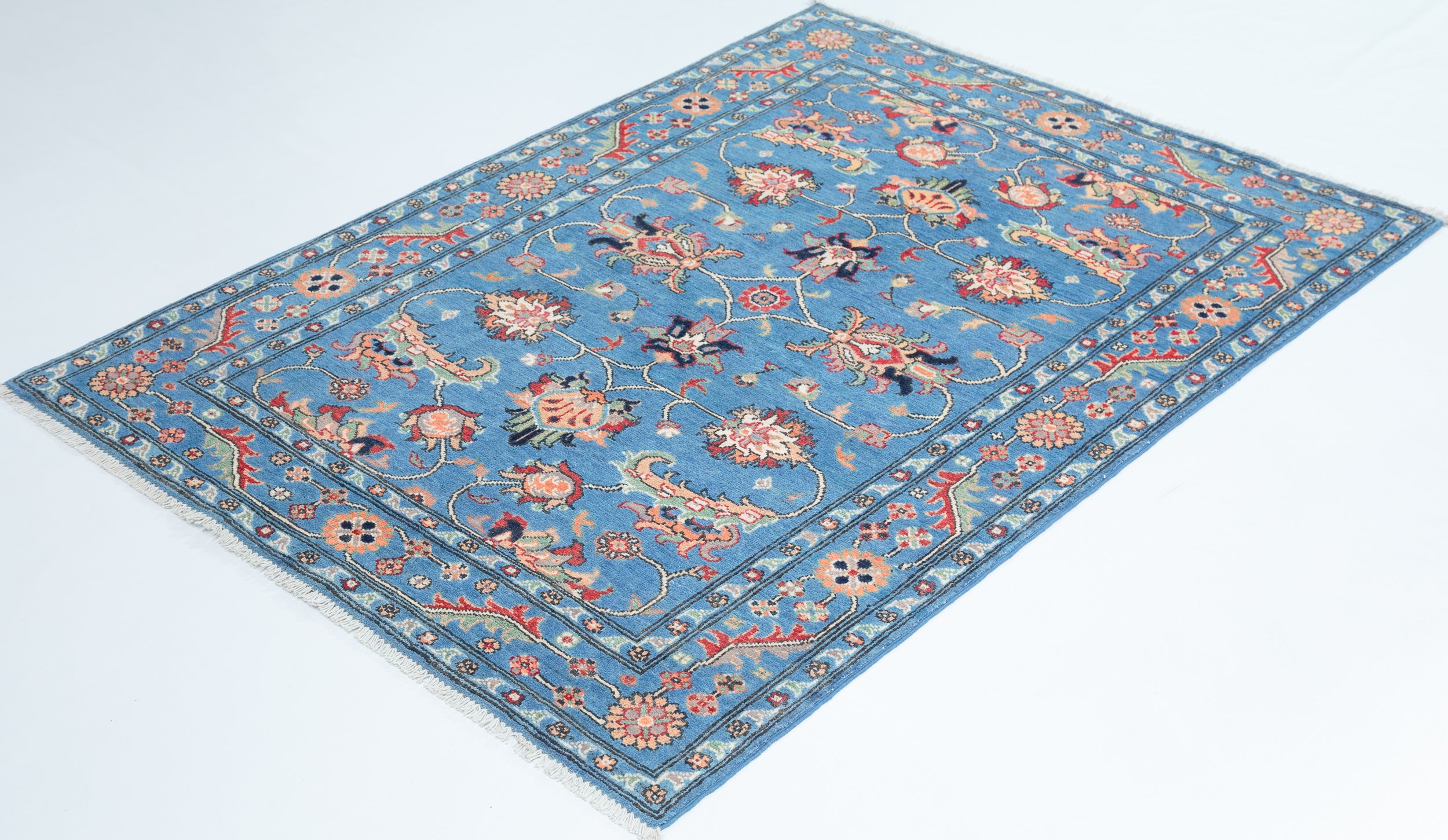 Full view at an angle of blue & red Kazak-inspired wool rug 29649.