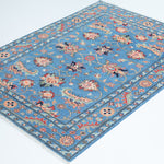 Full view at an angle of blue & red Kazak-inspired wool rug 29649.