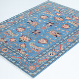Full view at an angle of blue & red Kazak-inspired wool rug 29649.