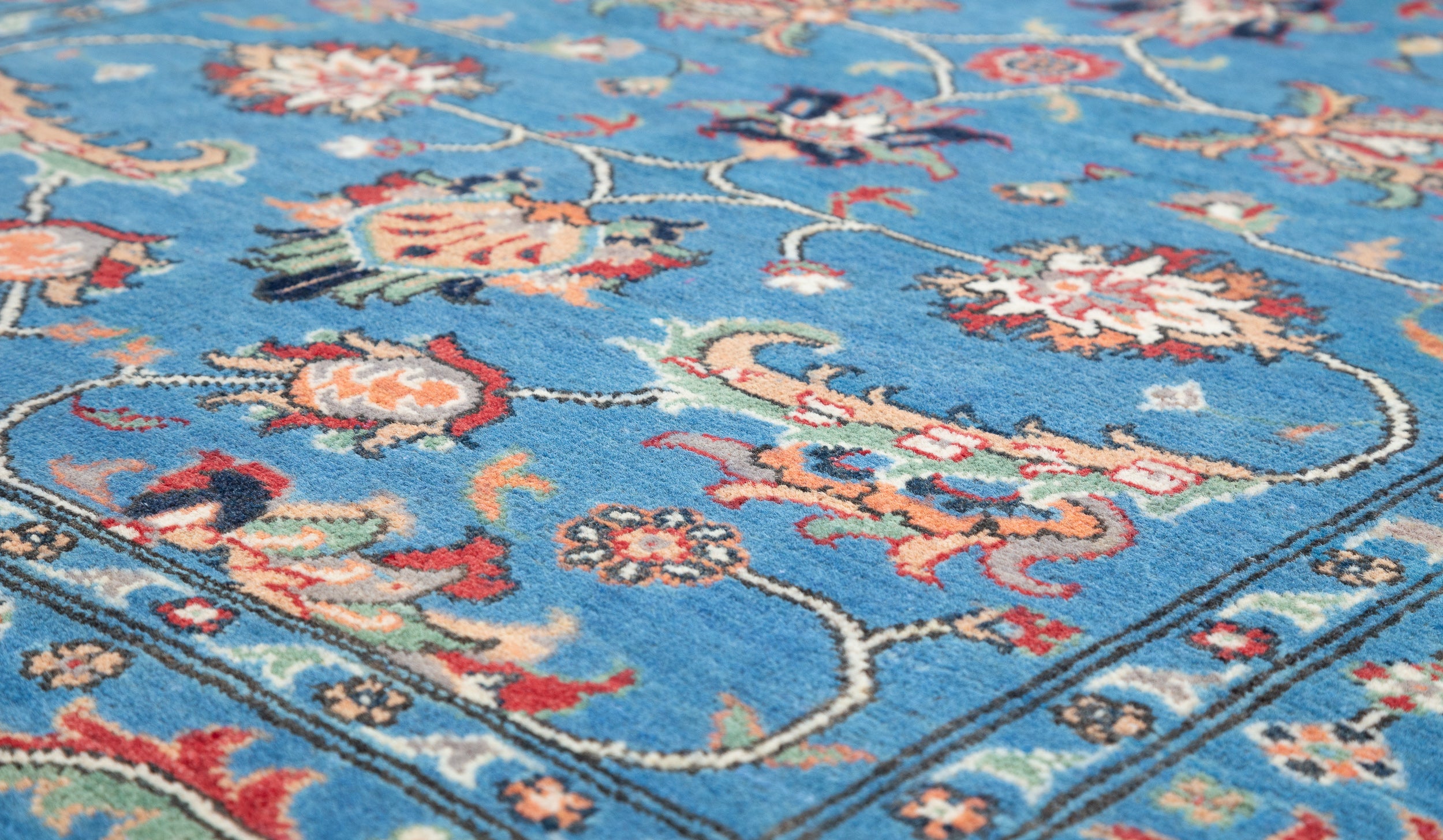 Pattern detail of blue & red Kazak-inspired wool rug 29649.