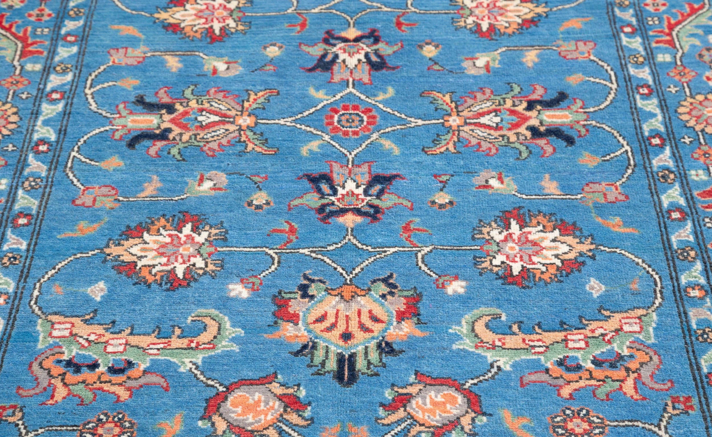 Pattern detail of blue & red Kazak-inspired wool rug 29649.