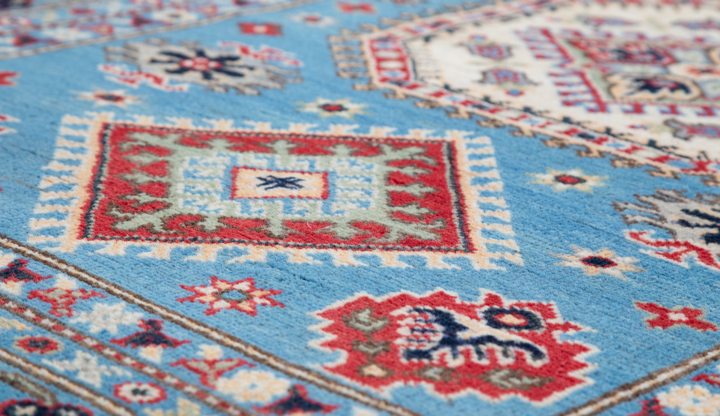 Pattern detail of blue & ivory Kazak-inspired wool rug 29650.