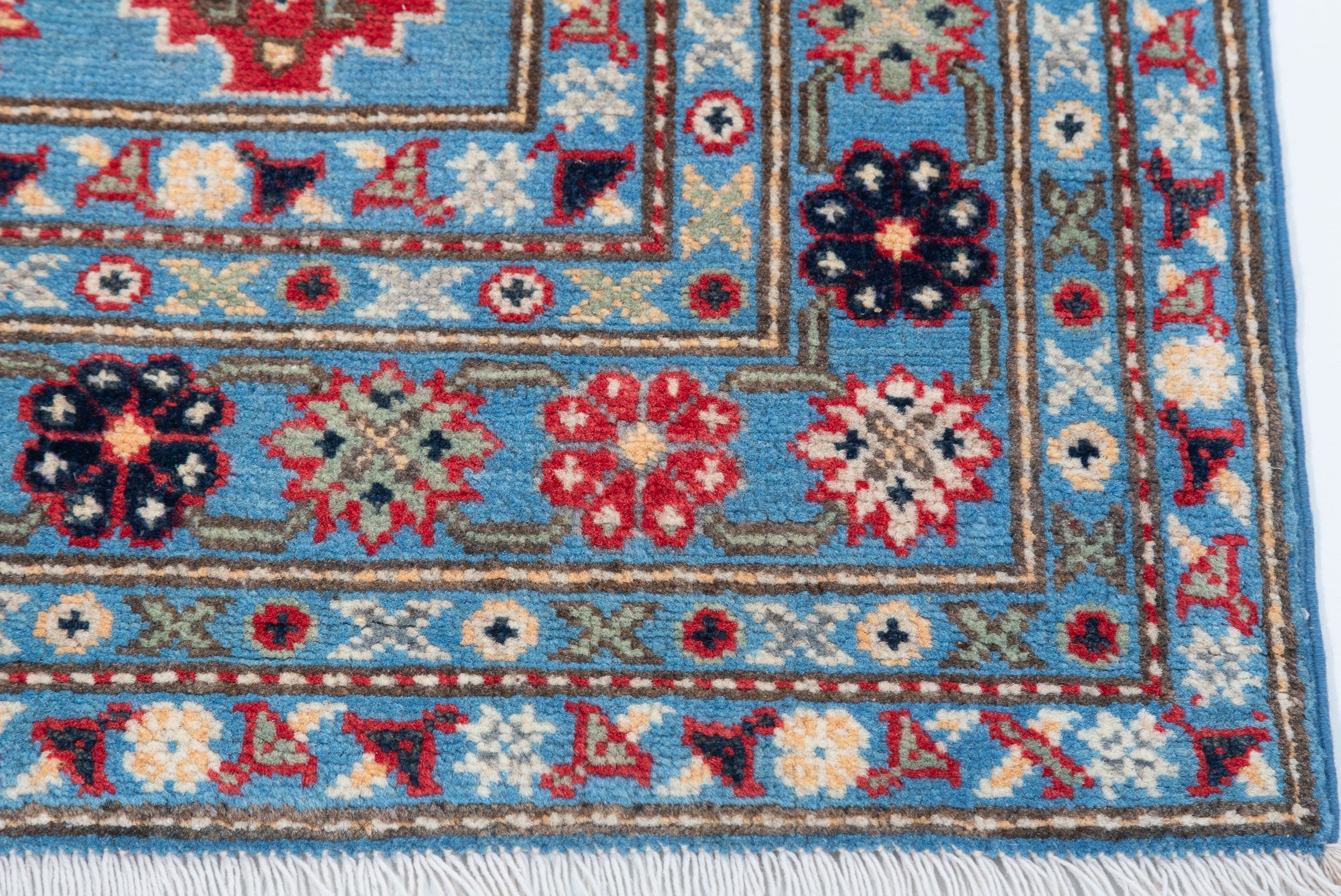 Border and edge detail of blue & ivory Kazak-inspired wool rug 29650.