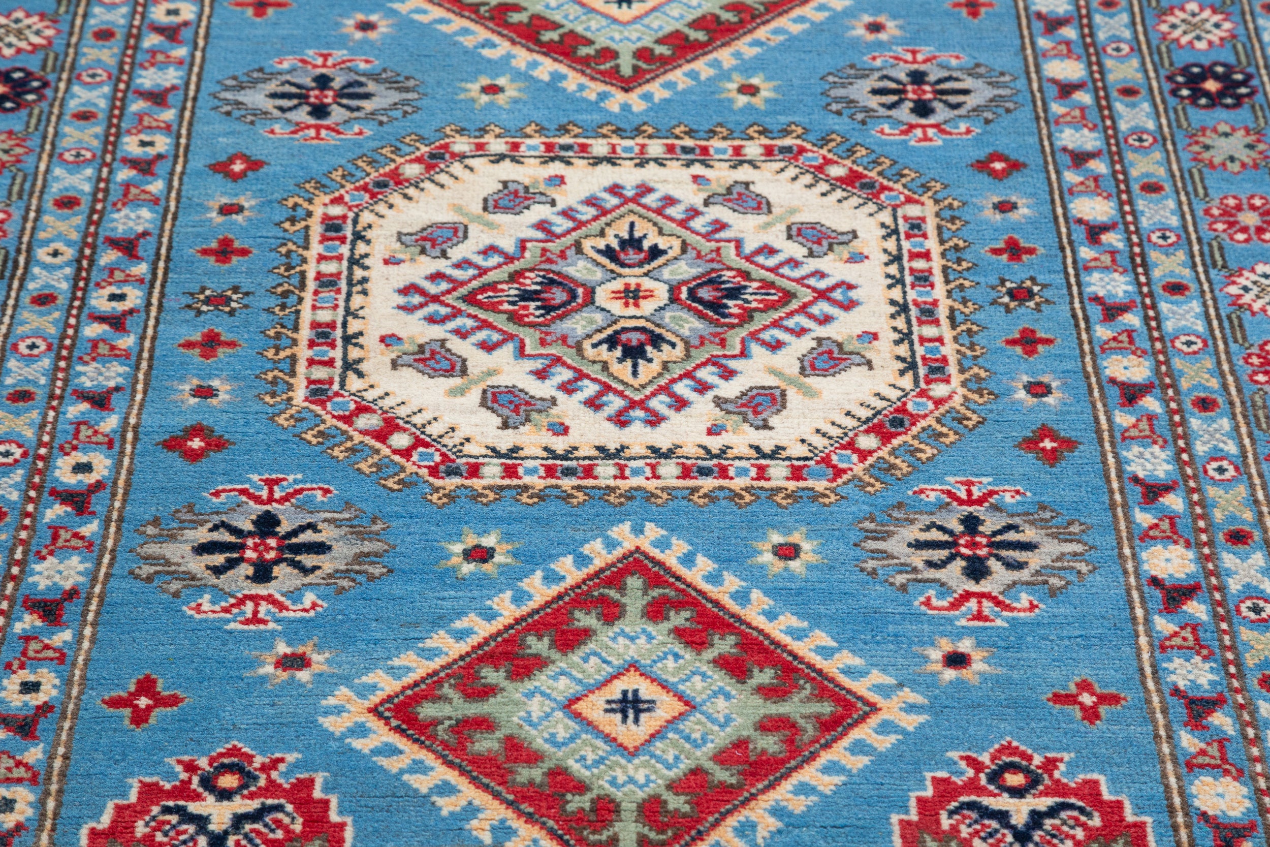 Pattern detail of blue & ivory Kazak-inspired wool rug 29650.