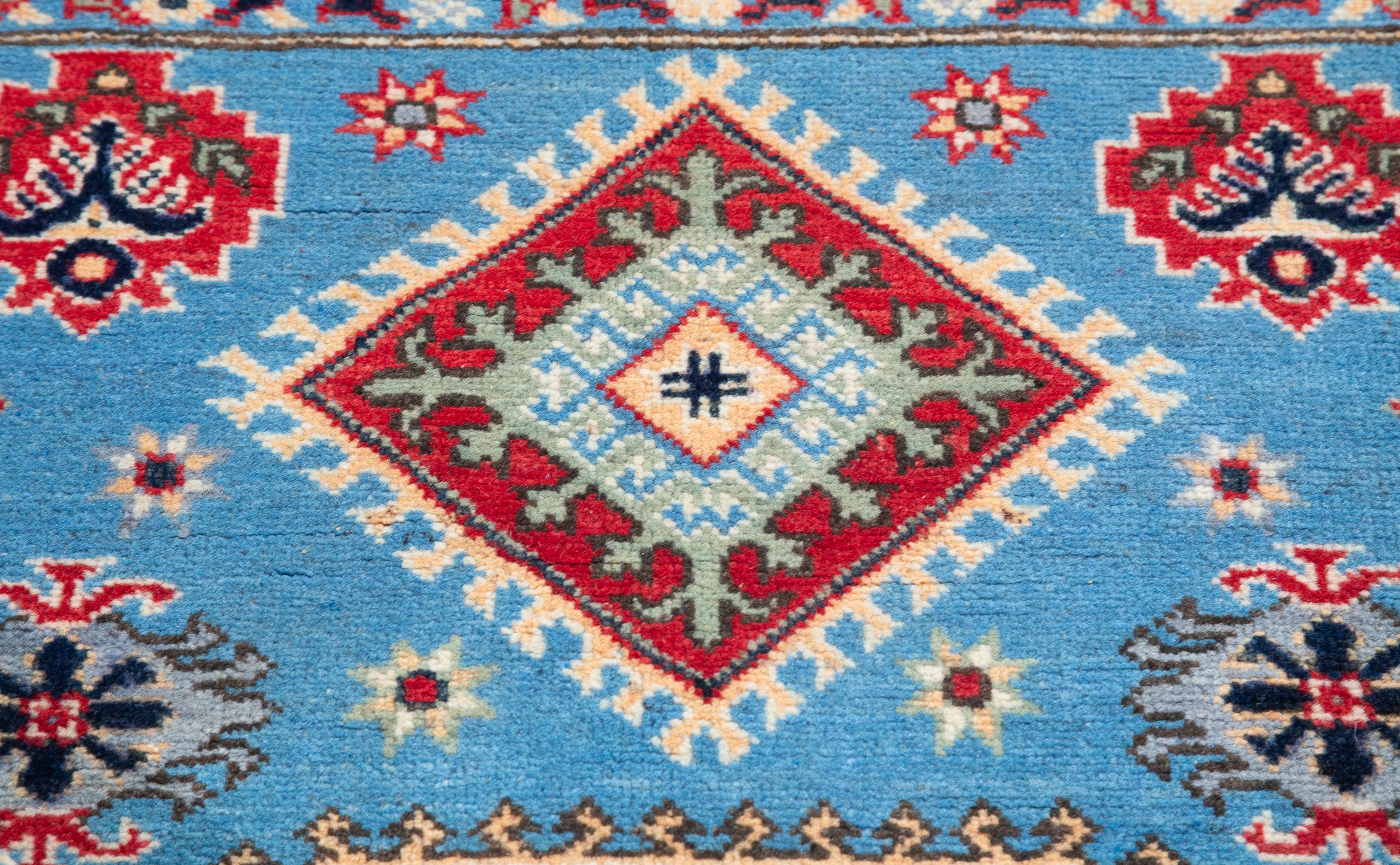Pattern detail of blue & ivory Kazak-inspired wool rug 29650.
