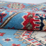 Folded edge and wool pile of blue & ivory Kazak-inspired wool rug 29650.