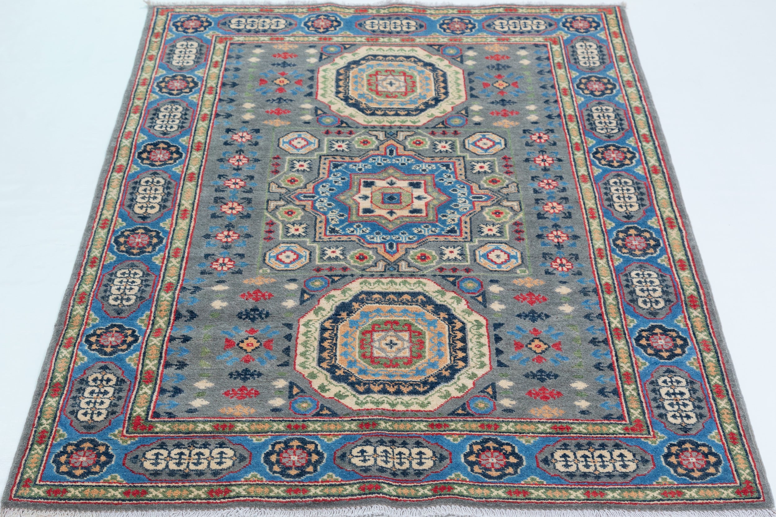 Full view from a low angle of blue & ivory Kazak-inspired wool rug 29651.