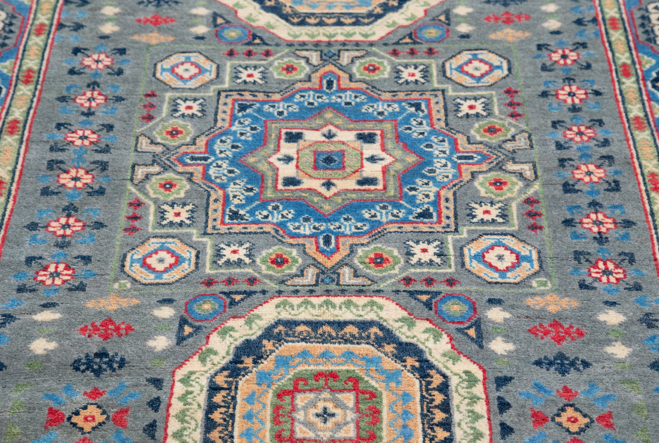 Pattern detail of blue & ivory Kazak-inspired wool rug 29651.