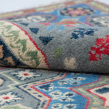 Folded edge and wool pile of blue & ivory Kazak-inspired wool rug 29651.
