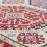Pattern detail of ivory & red Kazak-inspired wool rug 29652.